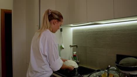 woman washing dishes in a kitchen
