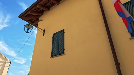 flags on a building in serralunga d'alba