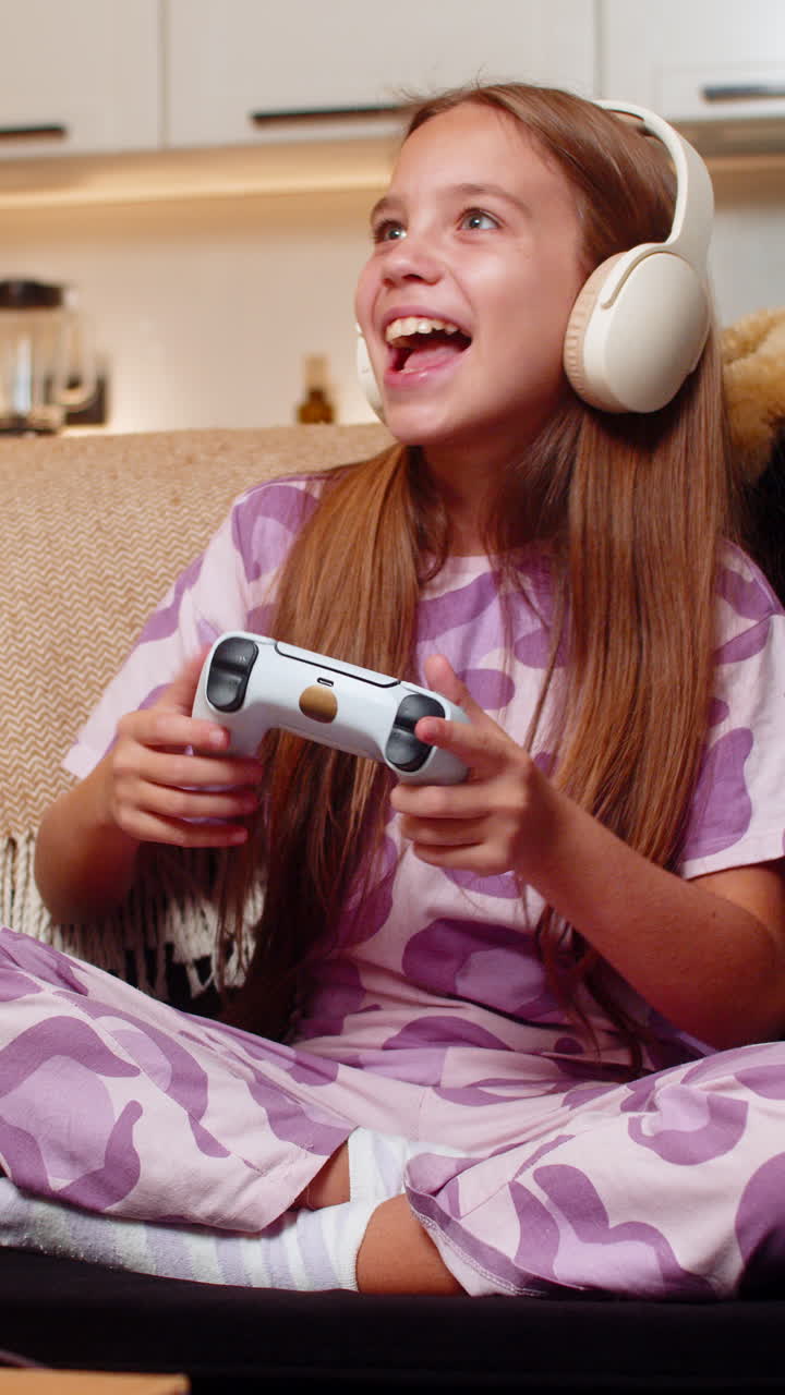 Teenager girl plays console game with joystick focused strong reaction enjoys free time after school