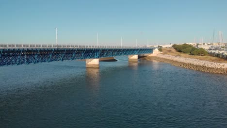 Aerial-backward-descending-shot-of-Portimao-car-bridge-in-Algarve,-Portugal