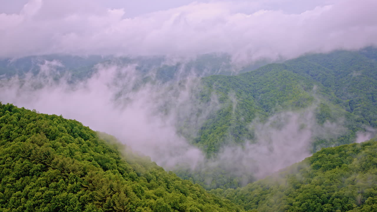 Slow sweeping drone shot of fog-covered hills in the Great Smoky range