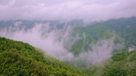 slow sweeping drone shot of fog-covered hills in the great smoky range