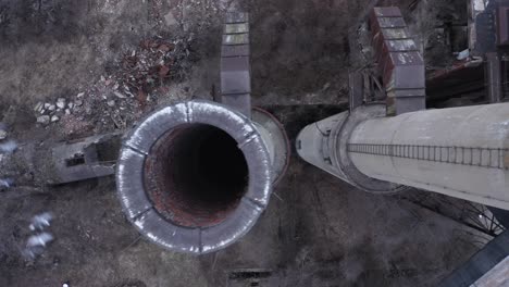 brick smokestacks are the only part left standing of an abandoned factory