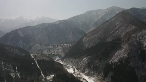 panoramic view of forested mountain ridges during winter near okuhida hirayu village in gifu, japan