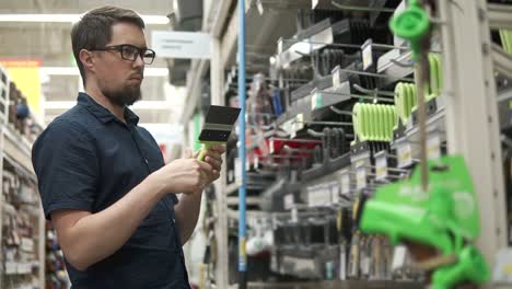 man shopping for tools in a hardware store
