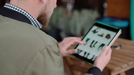 man shopping for shoes online on a tablet