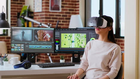 asian woman video creator uses virtual reality headset at her desk