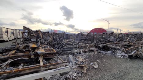 tracking shot junkyard view, many vehicles destroyed by fire, abbotsford, british columbia