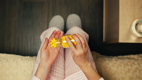 woman taking medication in pajamas