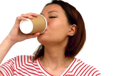 smiling asian woman drinking by disposable cup