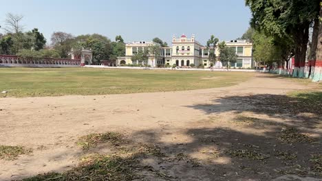 patna university surrounded with greenery and tall trees in bihar, india. day view.