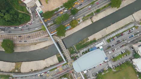 top-down aerial view of kuala lumpur, malaysia, revealing downtown streets, traffic, river, and urban structures in a bustling city environment