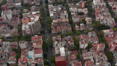 Aerial-flying-drone-view-of-residential-area-of-town.-Regular-square-mesh-of-street.-Cars-driving-on-multilane-one-way-street.-Mexico-city,-Mexico.