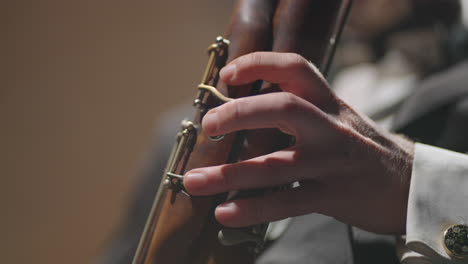 musician is playing wind instrument closeup view of hands on bassoon bassoonist is playing solo