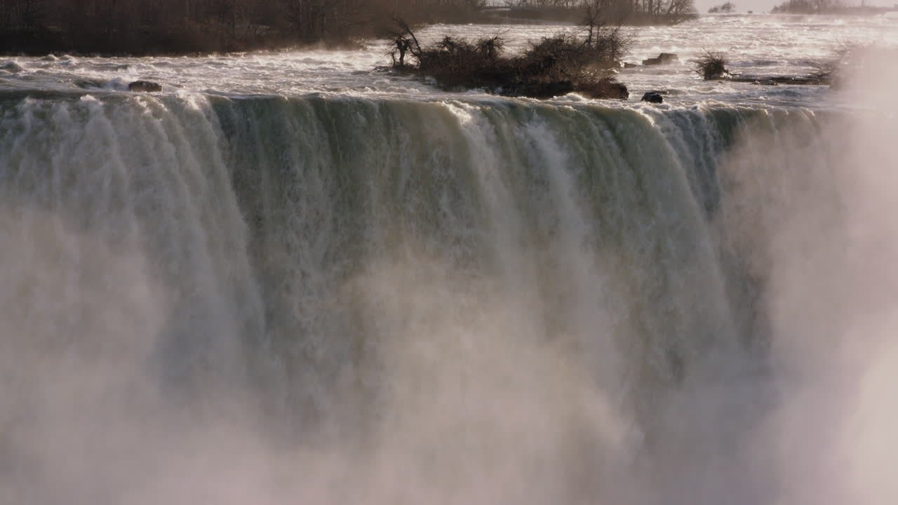 A waterfall crashes over the rocks at Niagara Falls.