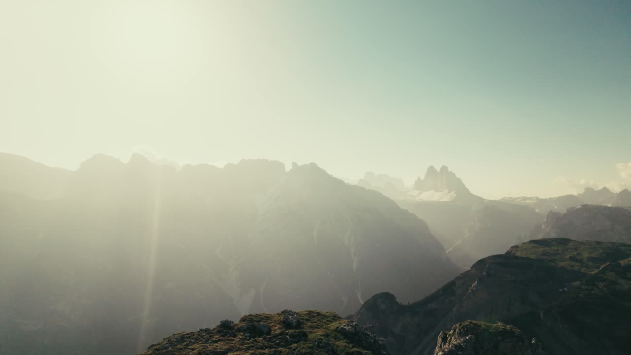 A person sitting on a mountain enjoying the sunrise in the Dolomites in South Tyrol.