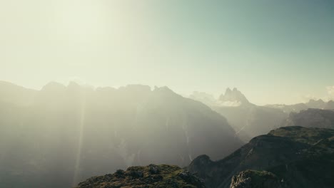 a person sitting on a mountain enjoying the sunrise in the dolomites in south tyrol.
