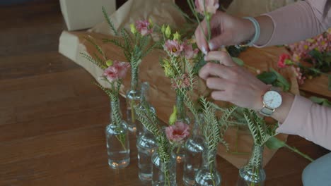 mujer preparando muchos ramos de flores para la decoración, vista de mano