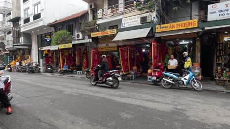 motorbikes and pedestrians in a busy market street