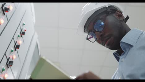 engineer inspecting electrical control panel