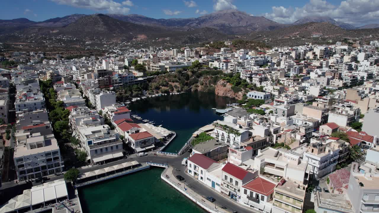 Pull back aerial shot of Lake Voulismeni in Agios Nikolaos, Crete, Greece