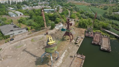 two underwater cranes stand idle on the pier shipyard