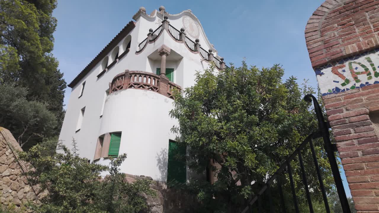 Casa Trias in Park Güell, Barcelona, with its historic charm and brown brick with white wall inspired architectural details, building in park