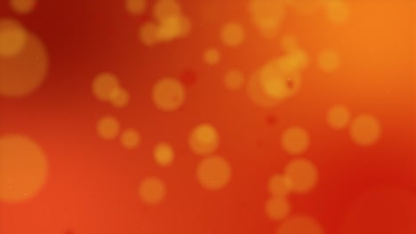 red particles falling on orange backdrop