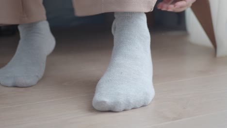 close-up of a woman's feet in grey socks