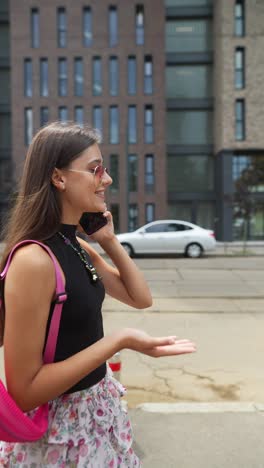 young woman talking on phone in the city