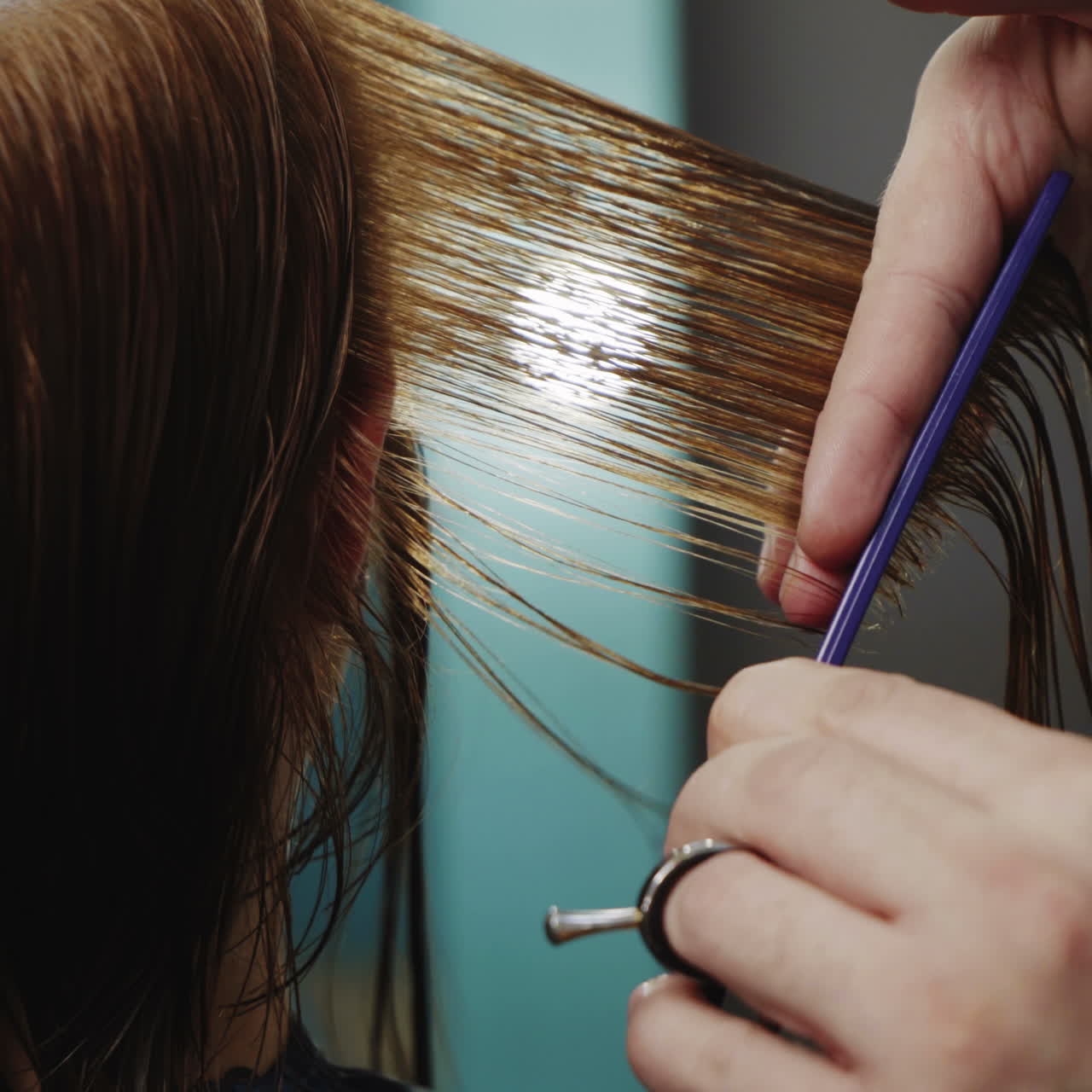 Women's haircut. Beautiful woman getting haircut by hairdresser in the beauty salon. Square video
