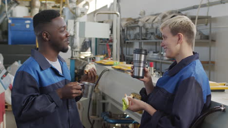 cheerful factory workers enjoying lunch break