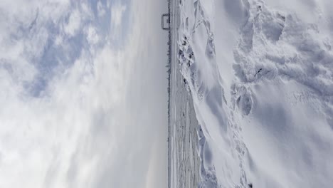 Vertical-nature-video,-Lake-Superior-covered-with-ice-formations-icebergs,-Minnesota