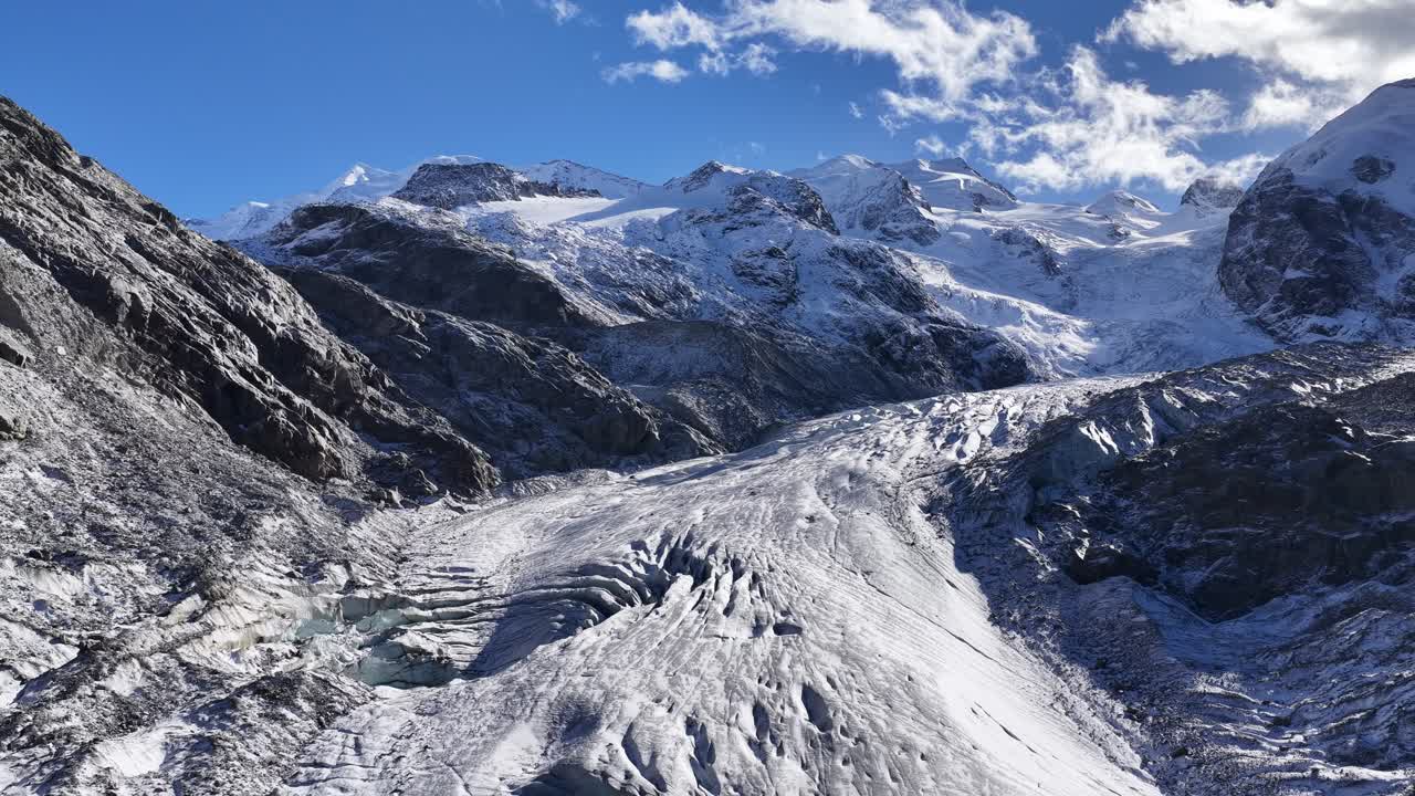 Aerial shot of ridged ice formations on Morteratsch Glacier beneath the Bernina peaks. Graubünden, Schweiz
