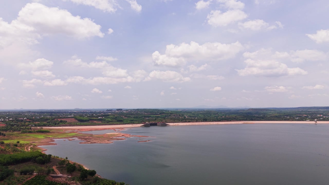 Las imágenes muestran el lago Ray en Vietnam. Se puede apreciar el agua cristalina y las orillas verdes. El sol brilla intensamente en el cielo azul. La naturaleza rodea la zona de observación.