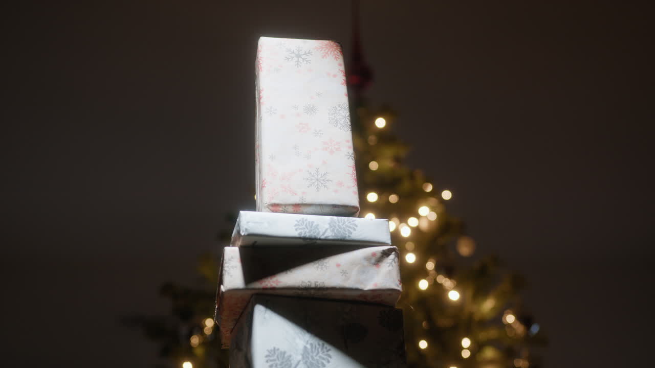 Christmas Presents Stacked in Front of the Illuminated Tree