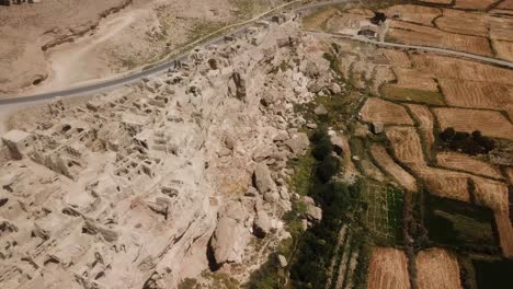 Historical-town-ruins-of-castle-village-large-adobe-city-farm-land-field-agriculture-nearby-silk-road-in-middle-east-a-complex-architecture-design-old-traditional-historical-local-people-life-in-Iran