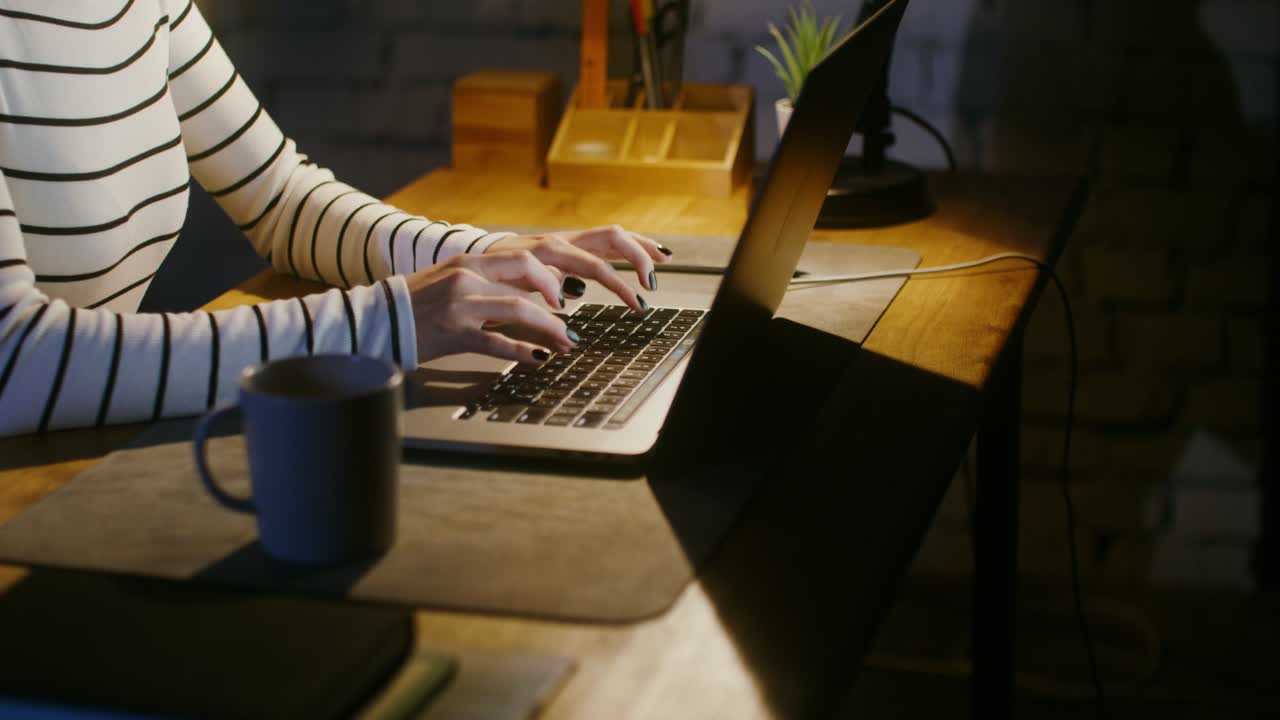 Woman working late on laptop at home
