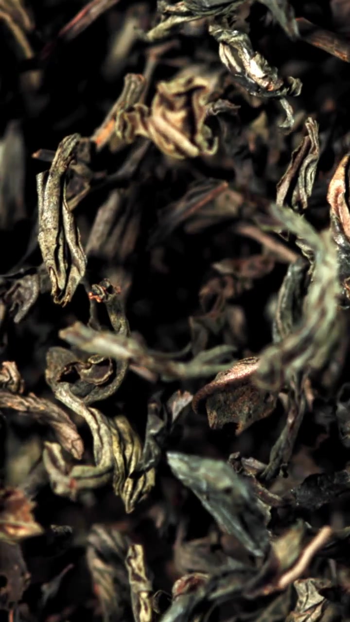 Macro Close-up of Dried Tea Leaves on a Black Background
