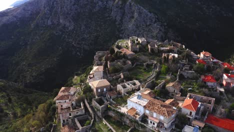 drone flight over old and historic hilly town of himara on ceraunian mountain ranges