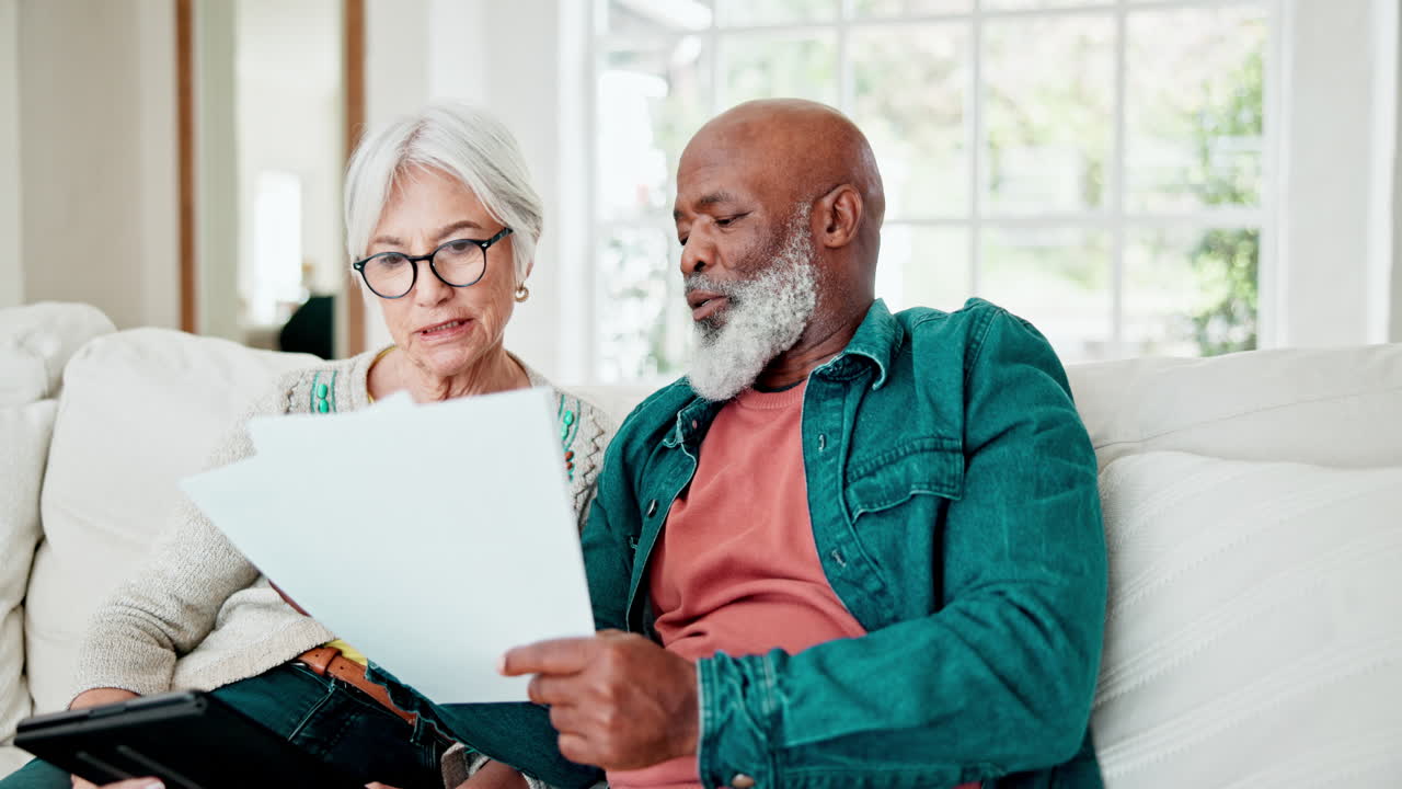Old couple on sofa with tablet