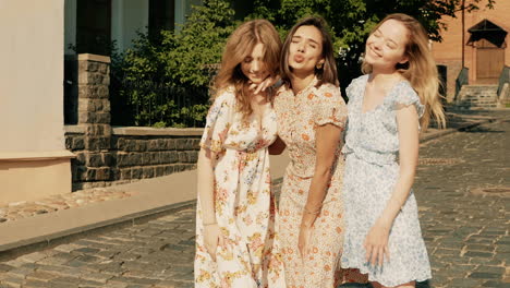 three friends in floral dresses