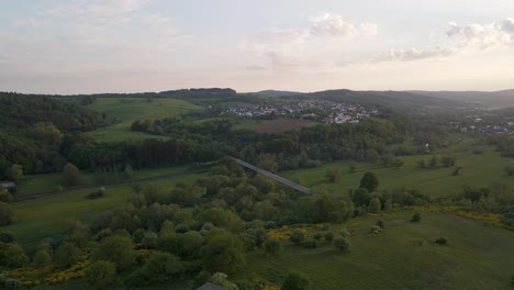 little white brick hut on the top of a green hill in germany's countryside