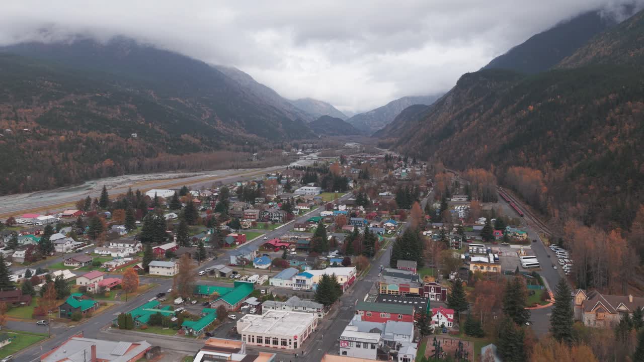 Wide aerial shot flying over historic downtown Skagway, Alaska in the fall. 4K