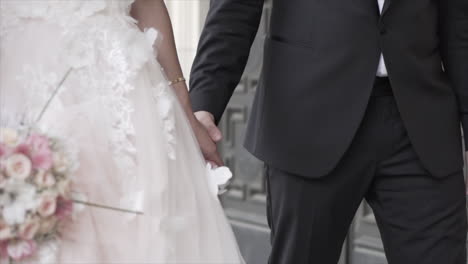 bride and groom holding hands