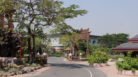 a tuk-tuk drives along a scenic park road.