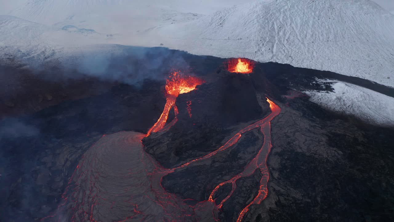 Aerial view away from volcano craters and lava, through steam and blizzard - reverse, drone shot