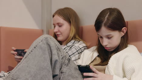 teenage girls using smartphones and tablets