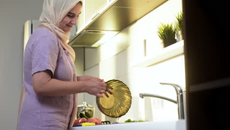 Side-view-of-woman-with-hiyab-in-the-kitchen.