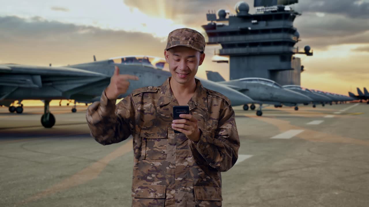 Military Personnel Using Smartphone on Aircraft Carrier Deck